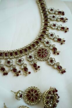 Samaira waterfall necklace set with maroon stones, matching jhumka earrings and tikka, South Asian festive jewelry