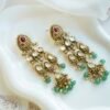 Slim kundan chandelier earrings in pink and green with pearl accents, South Asian festive jewelry
