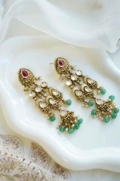 Slim kundan chandelier earrings in pink and green with pearl accents, South Asian festive jewelry