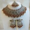Antique champagne Anya necklace set in orange with matching earrings and maang tikka