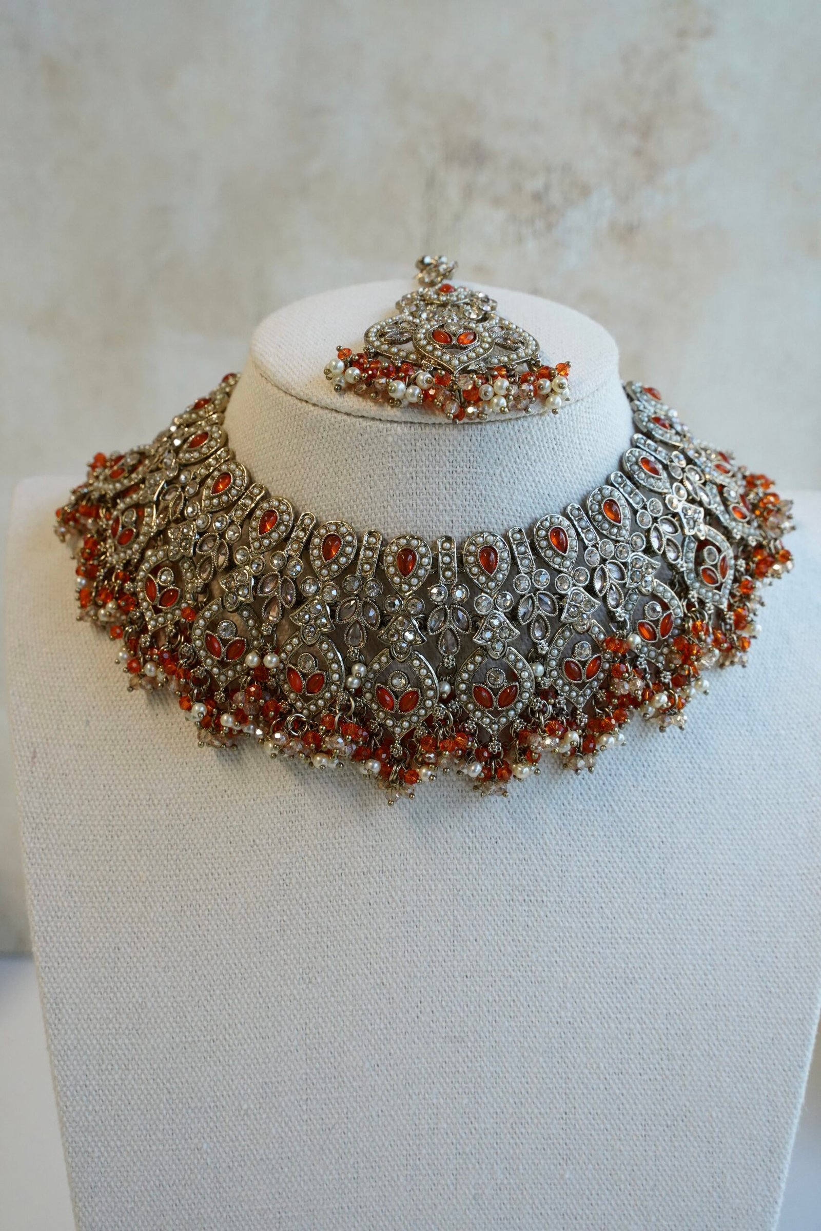 Antique champagne Anya necklace set in orange with matching earrings and maang tikka