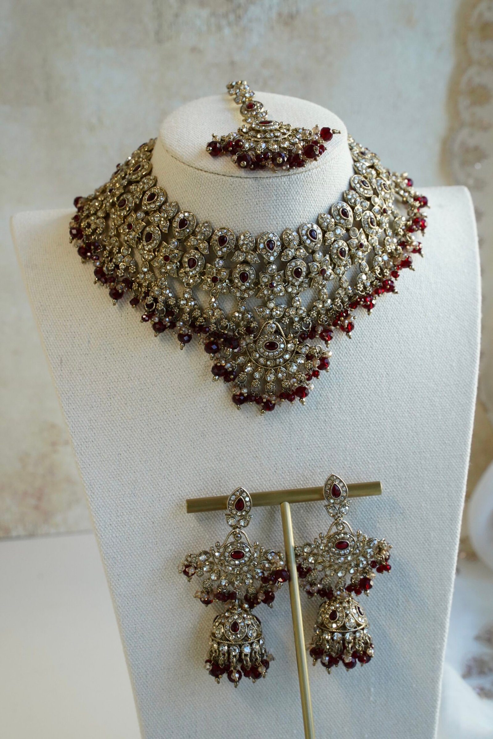 Maroon and antique champagne Arisha necklace set with matching earrings and maang tikka