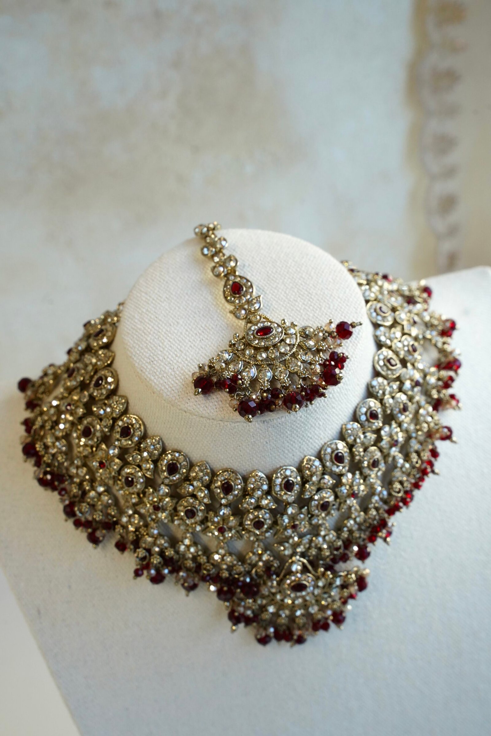 Maroon and antique champagne Arisha necklace set with matching earrings and maang tikka