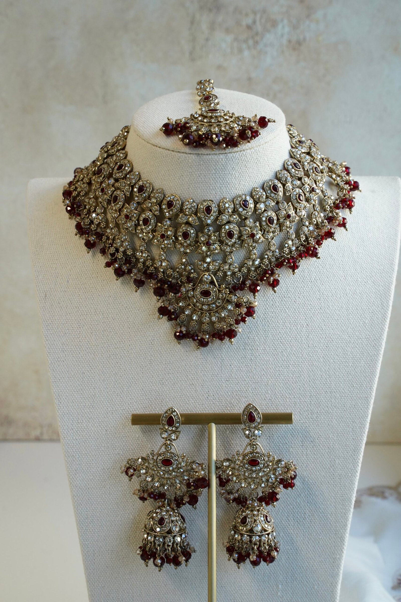 Maroon and antique champagne Arisha necklace set with matching earrings and maang tikka