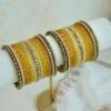 Golden Hour bangle set with gold ombre tones, stone detailing, and pearl trim