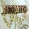 Maroon and antique gold connected bridal bangle set with hanging jhumka charms