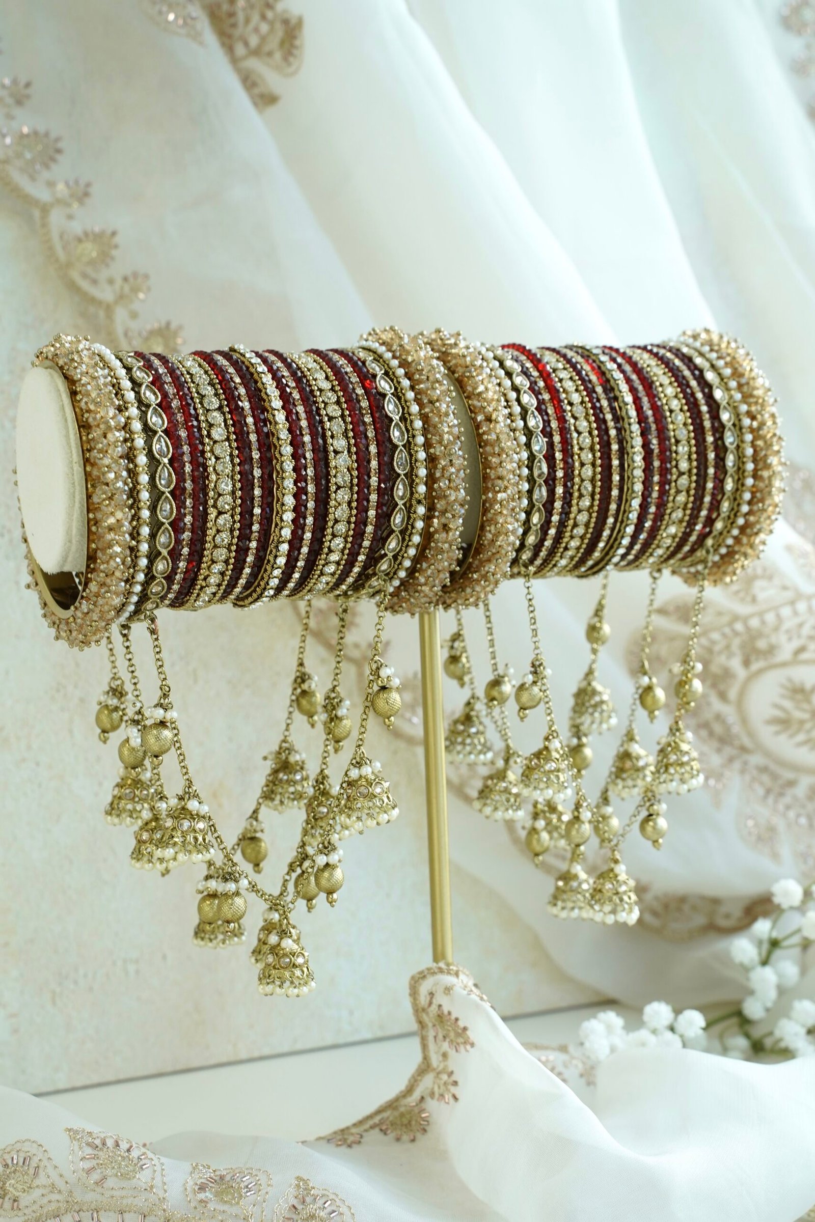 Maroon and antique gold connected bridal bangle set with hanging jhumka charms