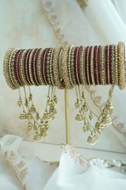 Maroon and antique gold connected bridal bangle set with hanging jhumka charms