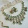 Mint Vine Necklace Set - antique gold necklace with mint stone clusters, pearl bead drops, jhumka earrings, and tikka