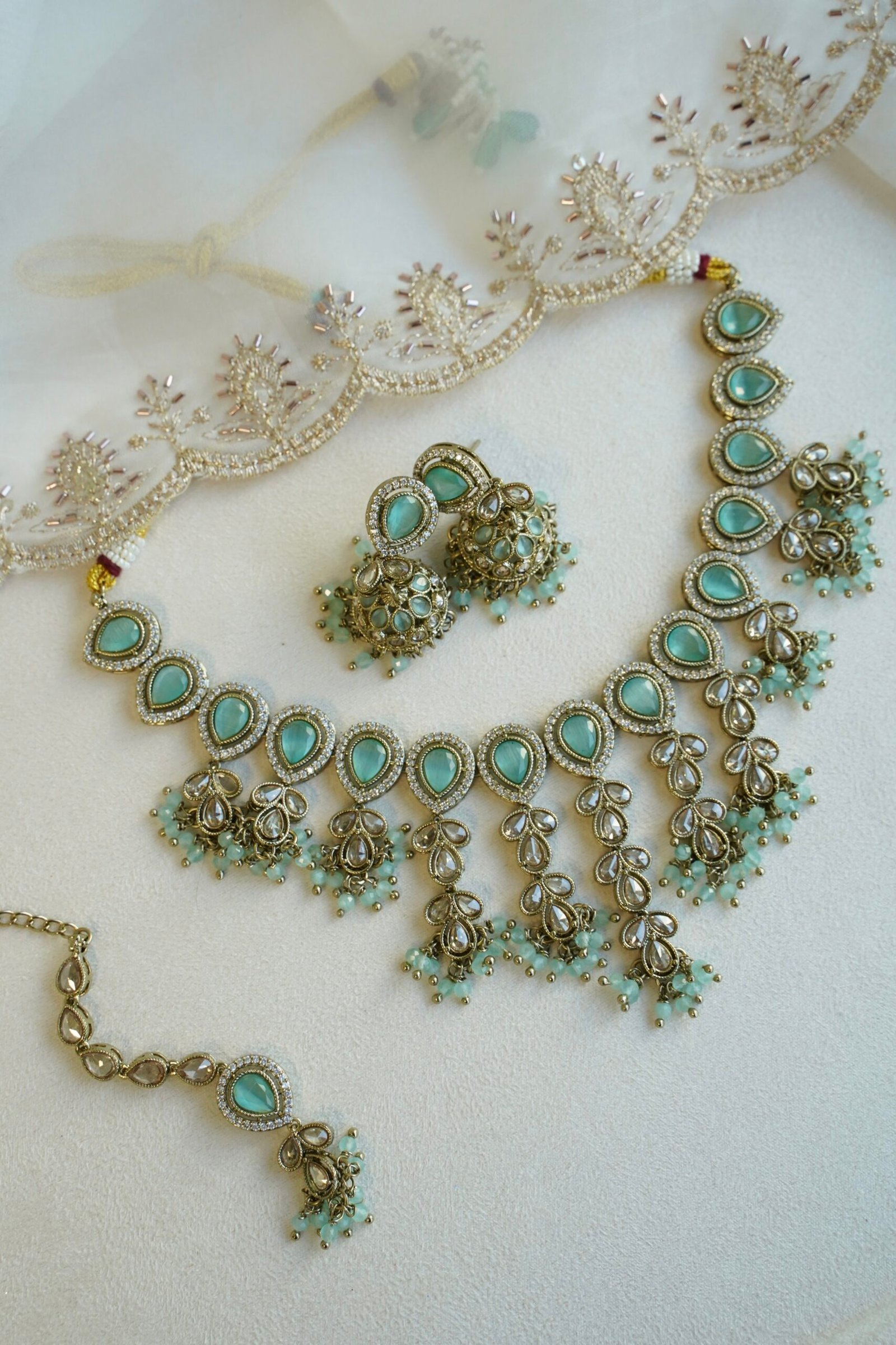 Mint Vine Necklace Set - antique gold necklace with mint stone clusters, pearl bead drops, jhumka earrings, and tikka