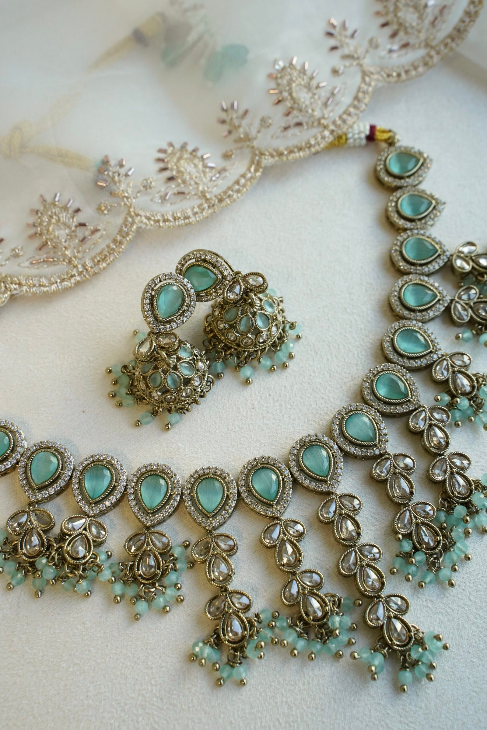 Mint Vine Necklace Set - antique gold necklace with mint stone clusters, pearl bead drops, jhumka earrings, and tikka