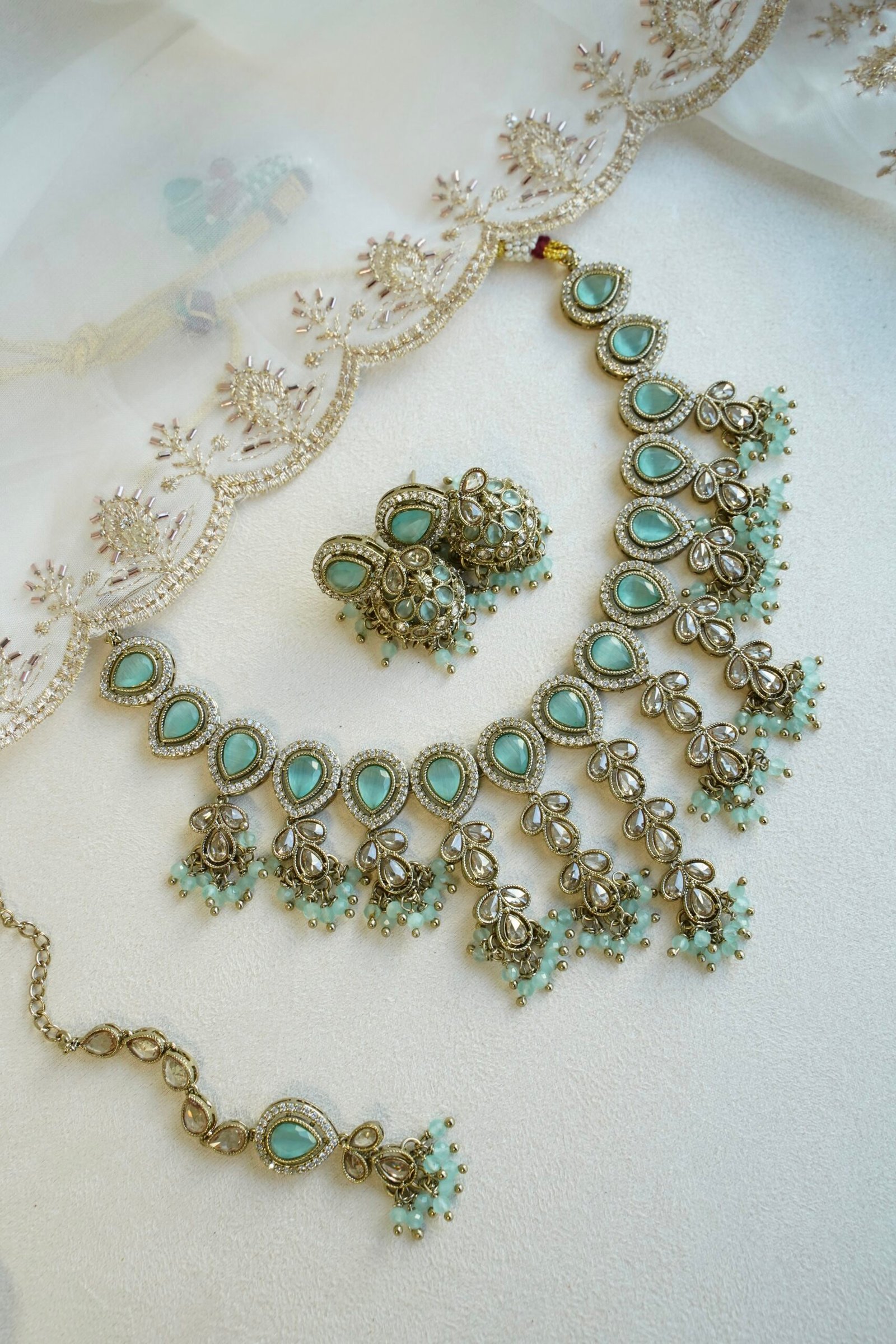 Mint Vine Necklace Set - antique gold necklace with mint stone clusters, pearl bead drops, jhumka earrings, and tikka