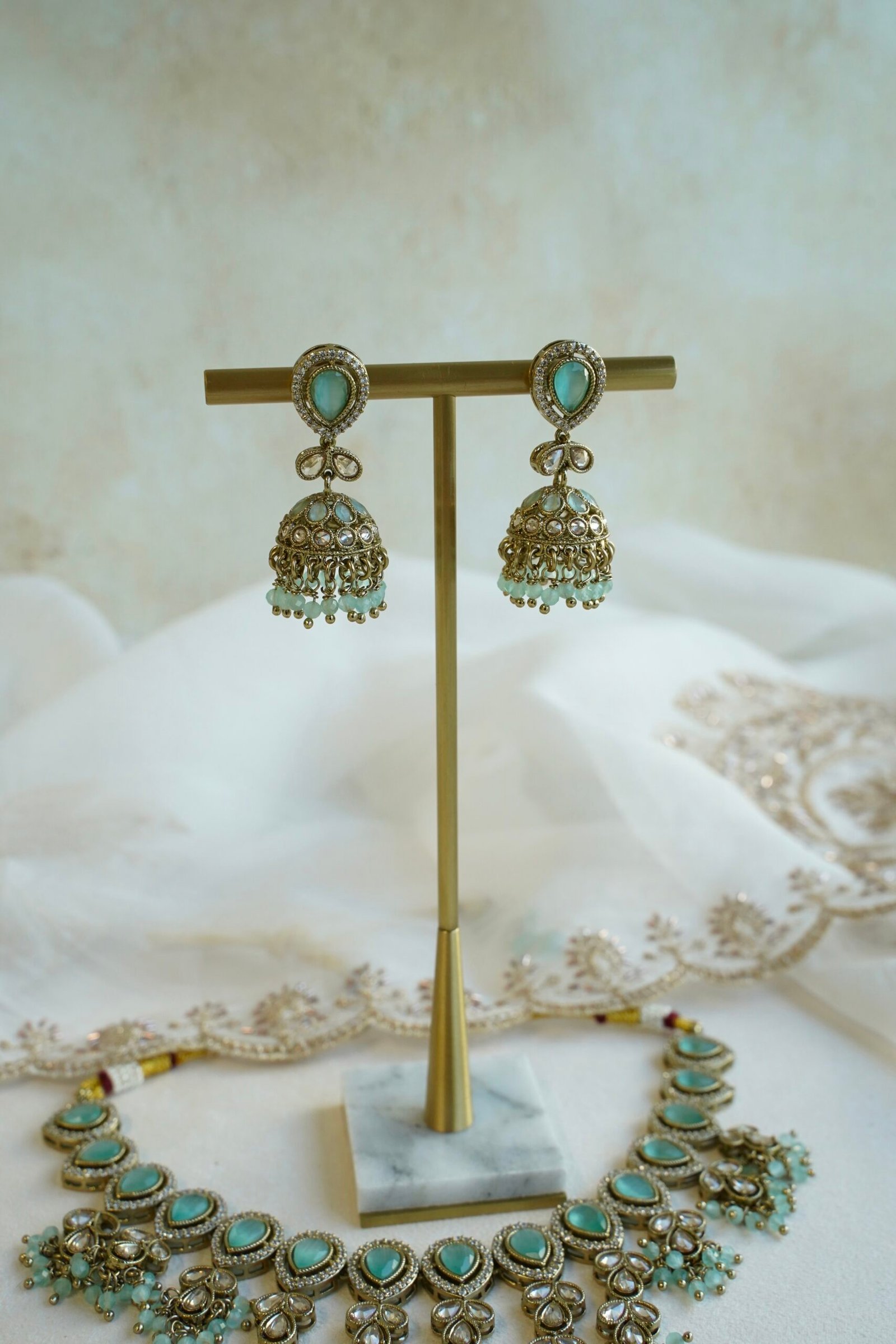 Mint Vine Necklace Set - antique gold necklace with mint stone clusters, pearl bead drops, jhumka earrings, and tikka