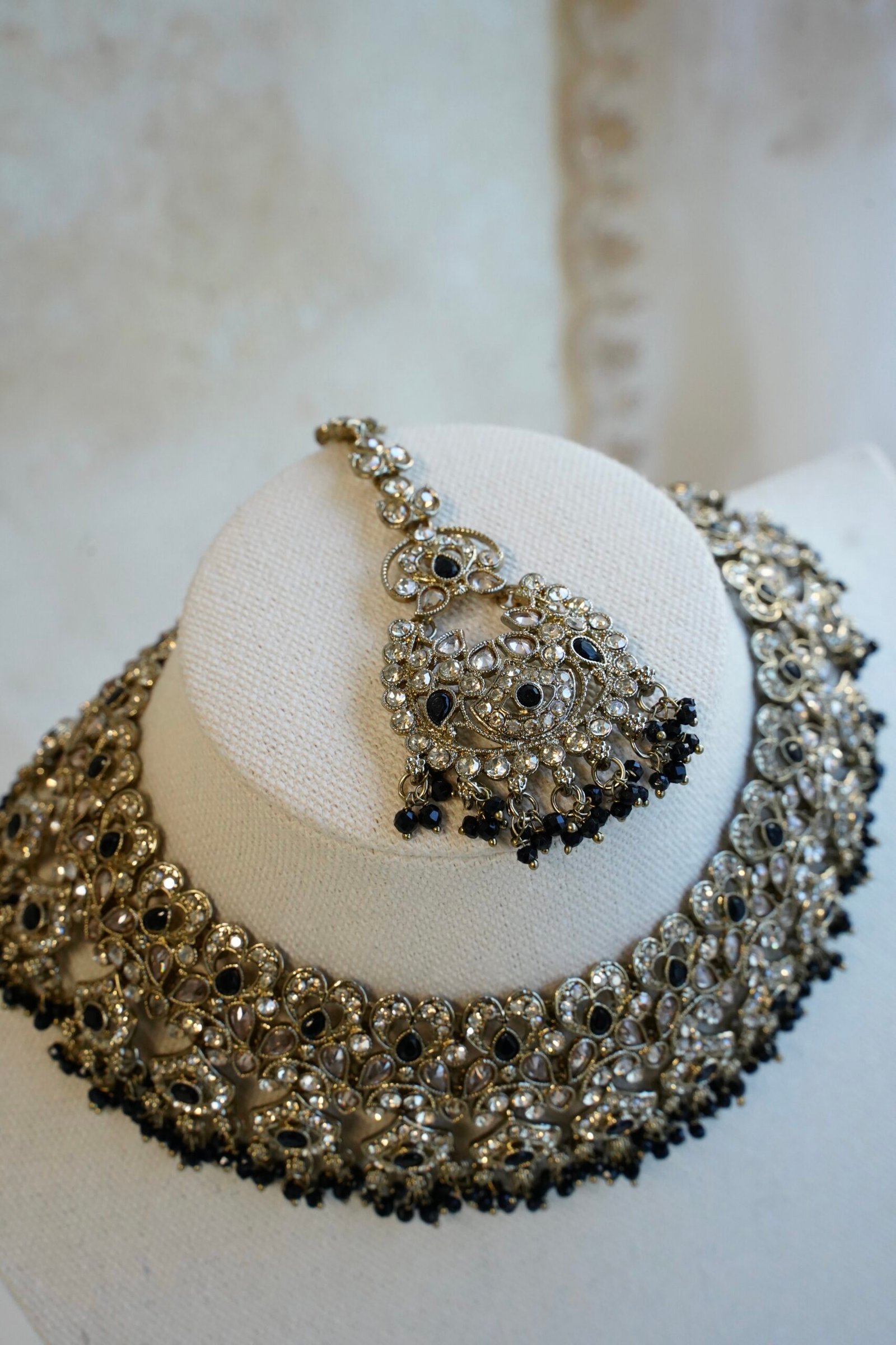 Antique gold Moni black necklace set with black stone accents and bead fringe