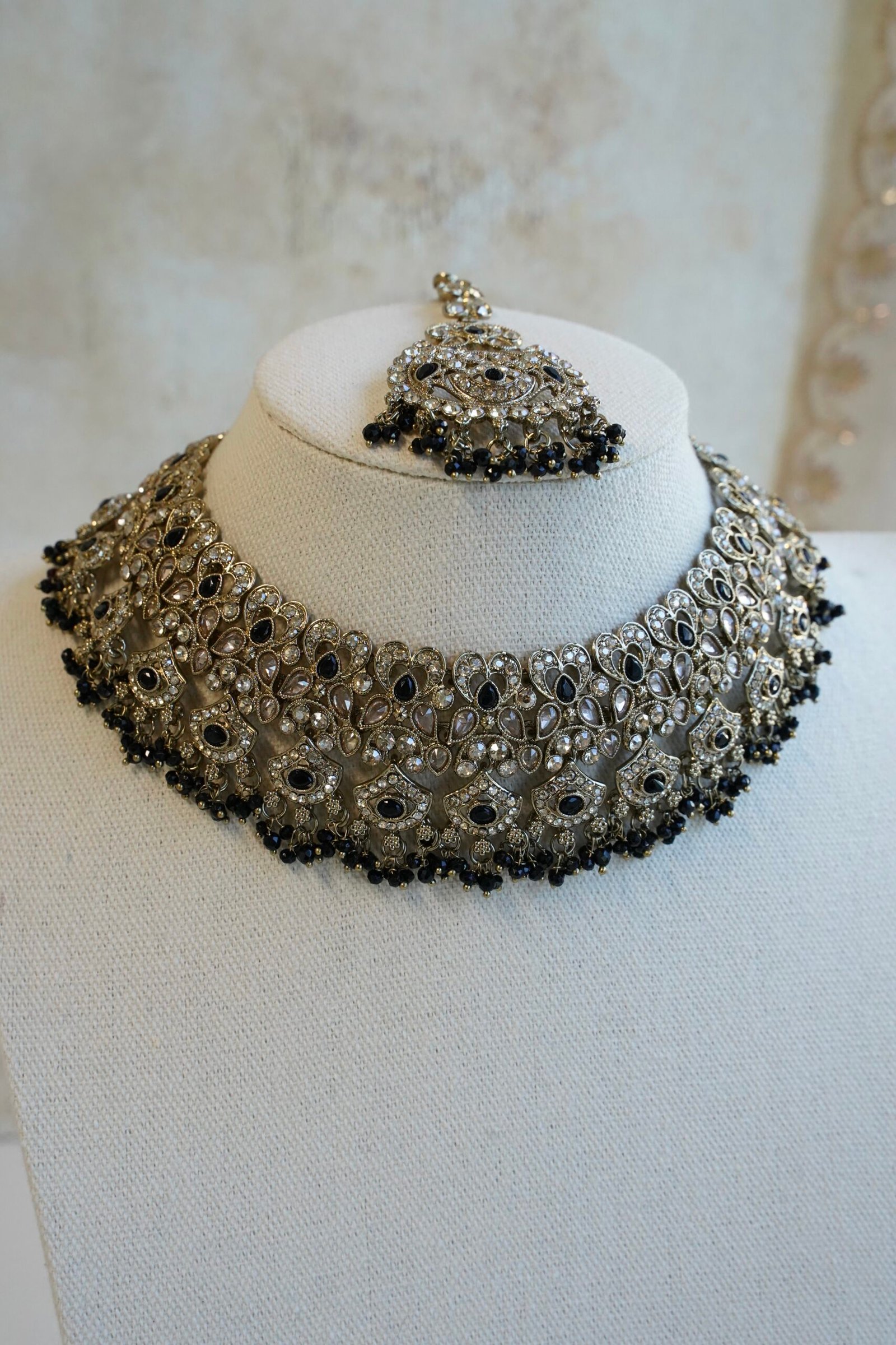 Antique gold Moni black necklace set with black stone accents and bead fringe