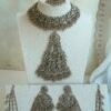 Light pink and champagne gold Nazneen bridal set with jhumar, earrings, nath, and tikka
