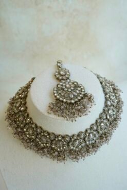Light pink and champagne gold Nazneen bridal set with jhumar, earrings, nath, and tikka
