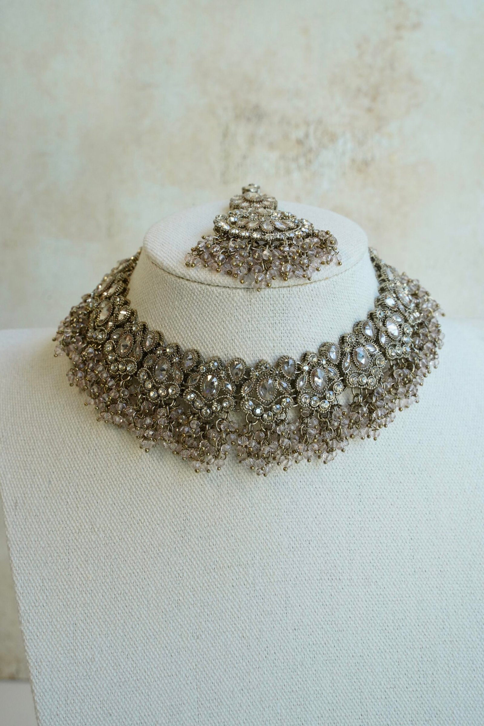 Light pink and champagne gold Nazneen bridal set with jhumar, earrings, nath, and tikka