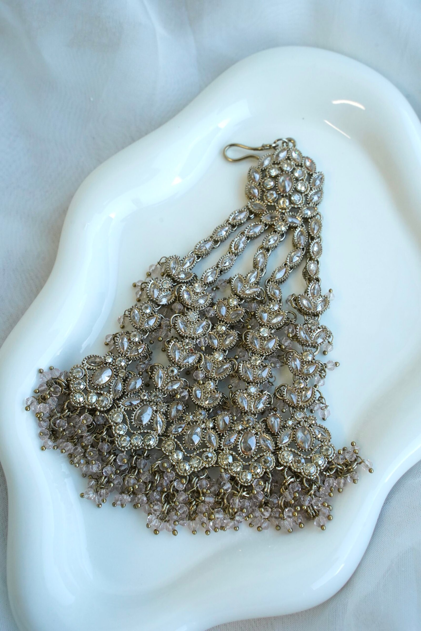 Light pink and champagne gold Nazneen bridal set with jhumar, earrings, nath, and tikka
