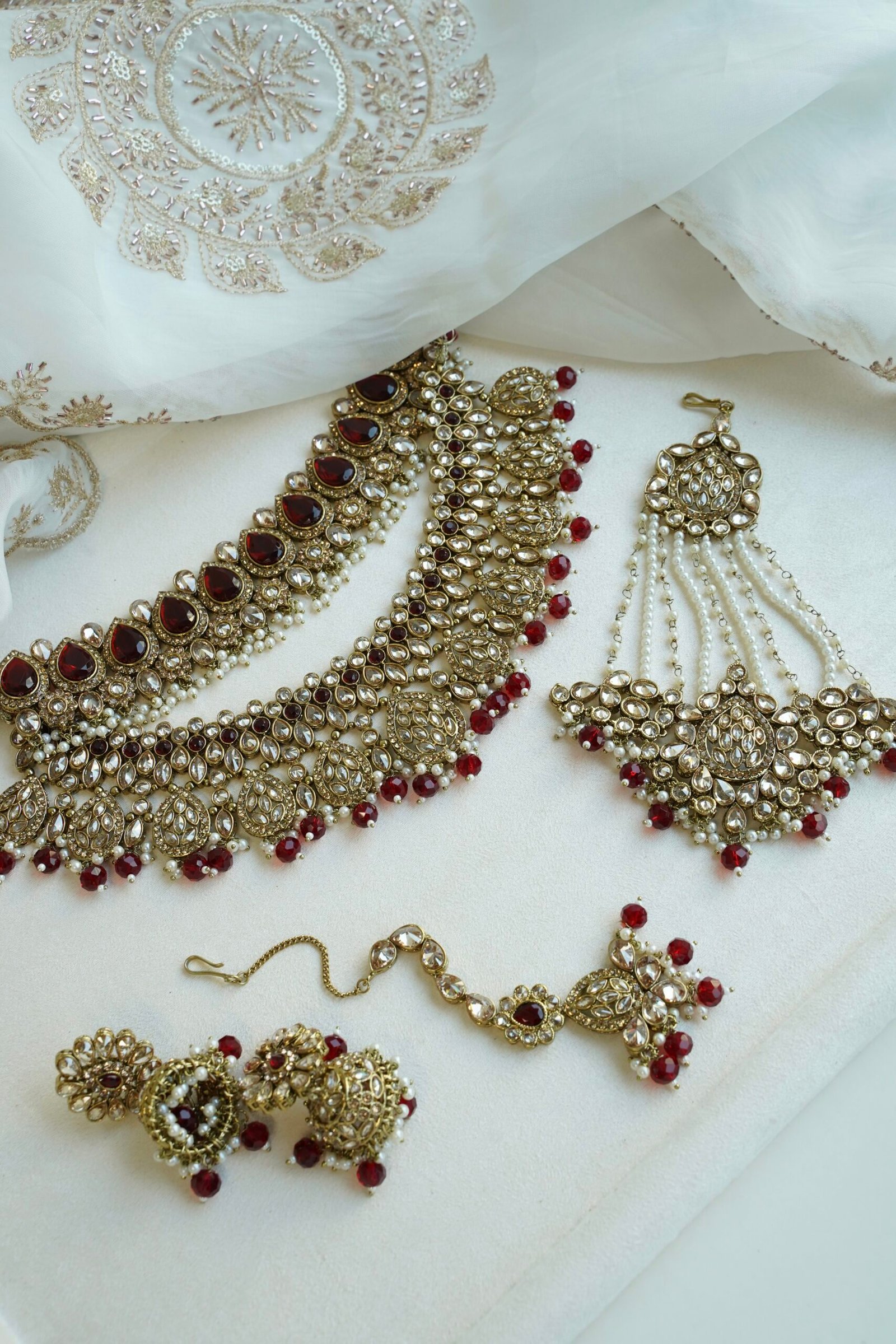 Zeenat Maroon Bridal Set - antique gold kundan bridal jewelry set with layered choker necklace, jhumar, jhumka earrings, and tikka