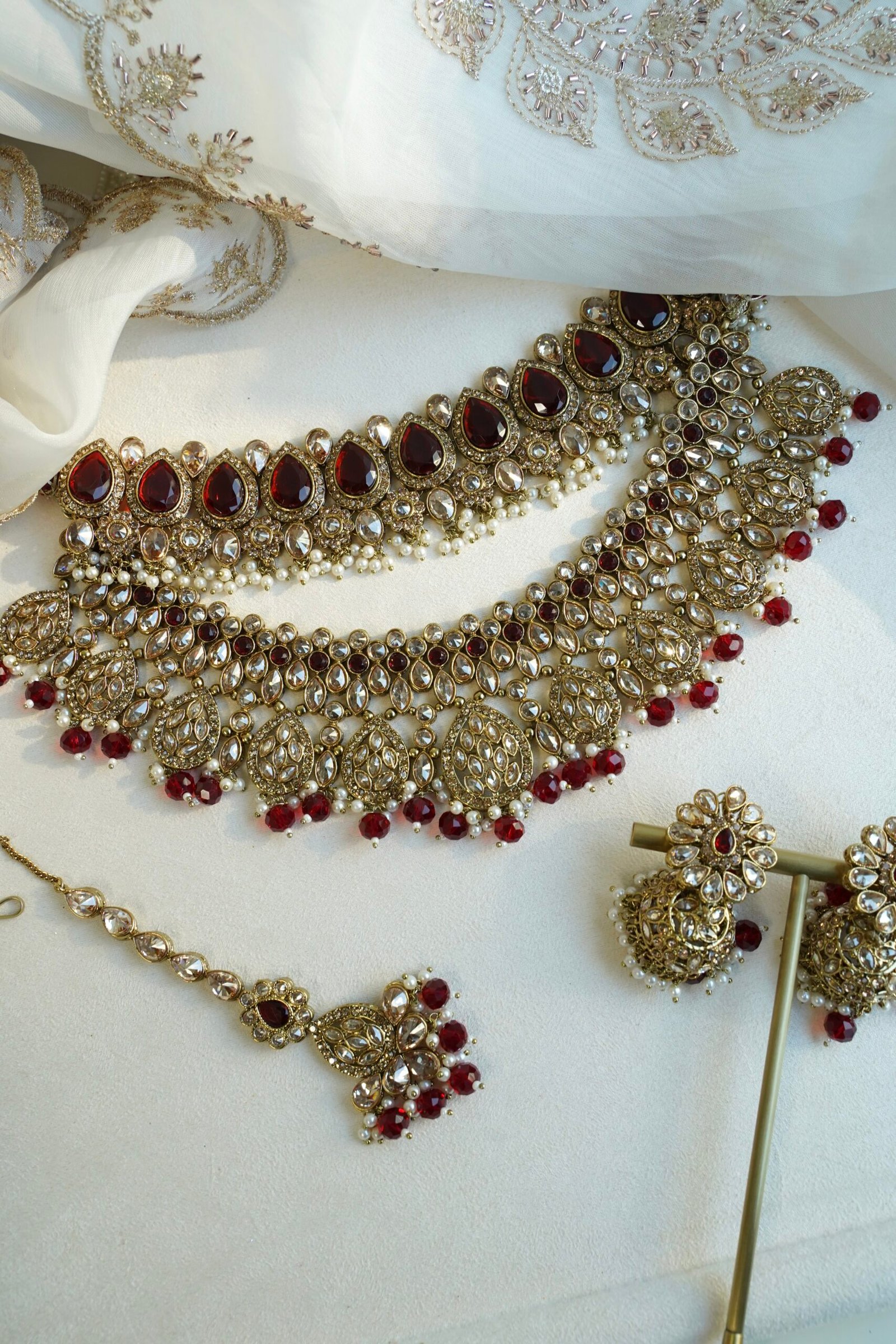 Zeenat Maroon Bridal Set - antique gold kundan bridal jewelry set with layered choker necklace, jhumar, jhumka earrings, and tikka