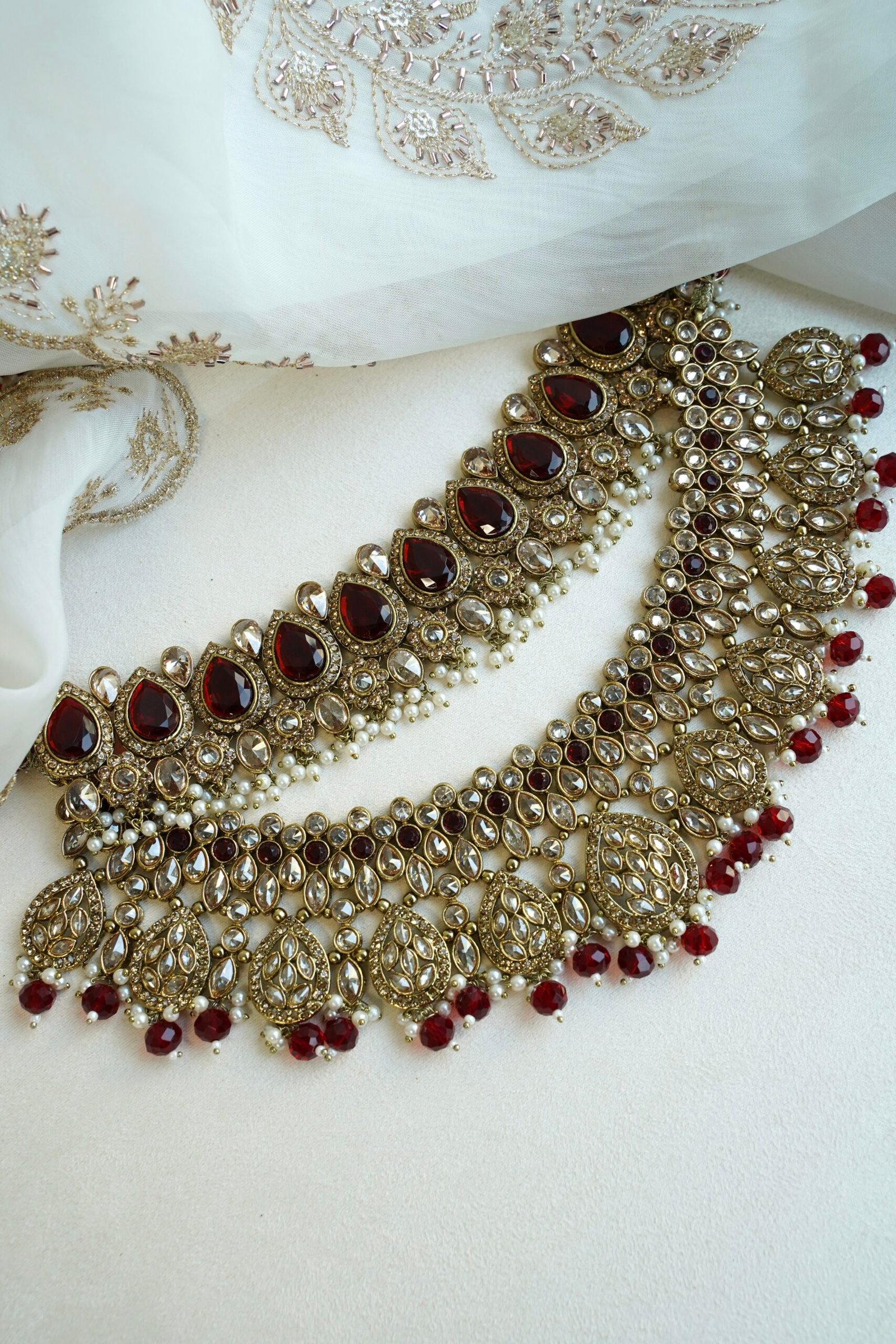 Zeenat Maroon Bridal Set - antique gold kundan bridal jewelry set with layered choker necklace, jhumar, jhumka earrings, and tikka