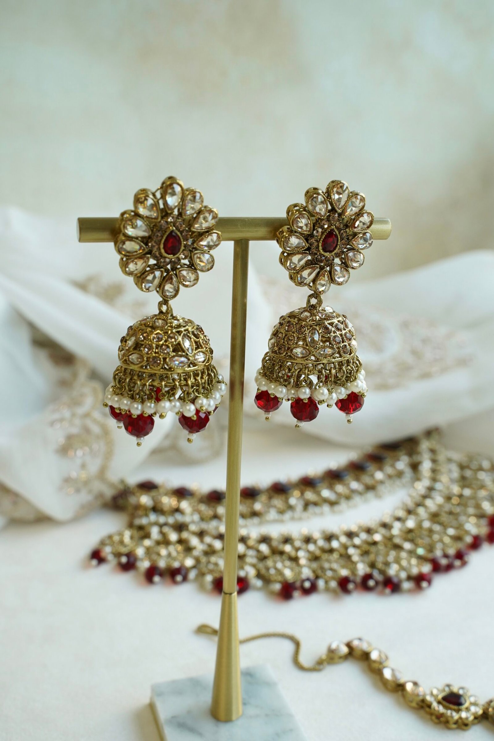 Zeenat Maroon Bridal Set - antique gold kundan bridal jewelry set with layered choker necklace, jhumar, jhumka earrings, and tikka