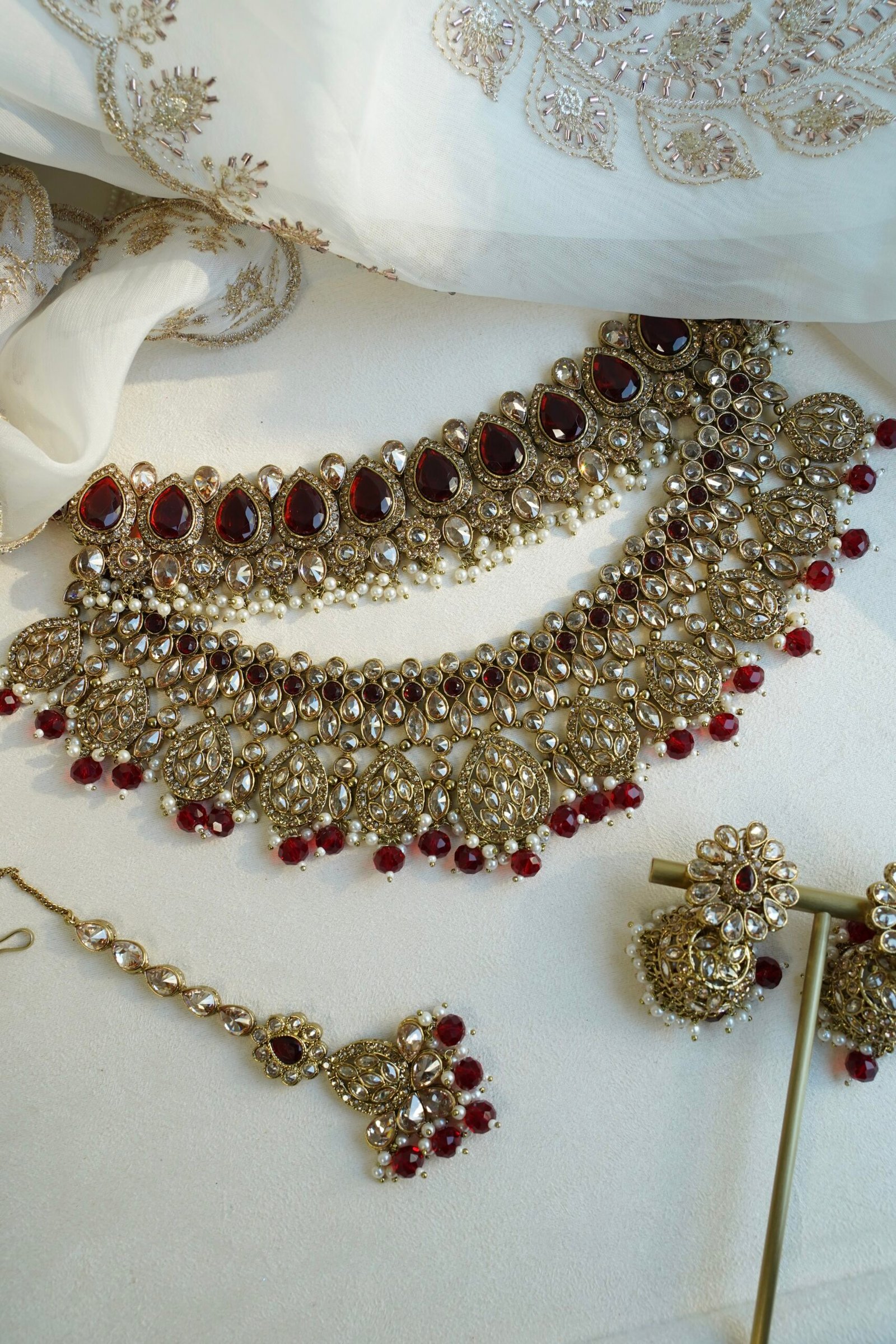 Zeenat Maroon Bridal Set - antique gold kundan bridal jewelry set with layered choker necklace, jhumar, jhumka earrings, and tikka