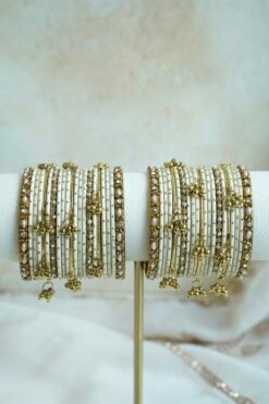 Soft ivory and gold ghungroo bangle set with pearl and stone accents, South Asian festive jewelry