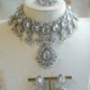 Amyra silver choker necklace set with clear stones, pendant drop, tikka, and jhumka earrings