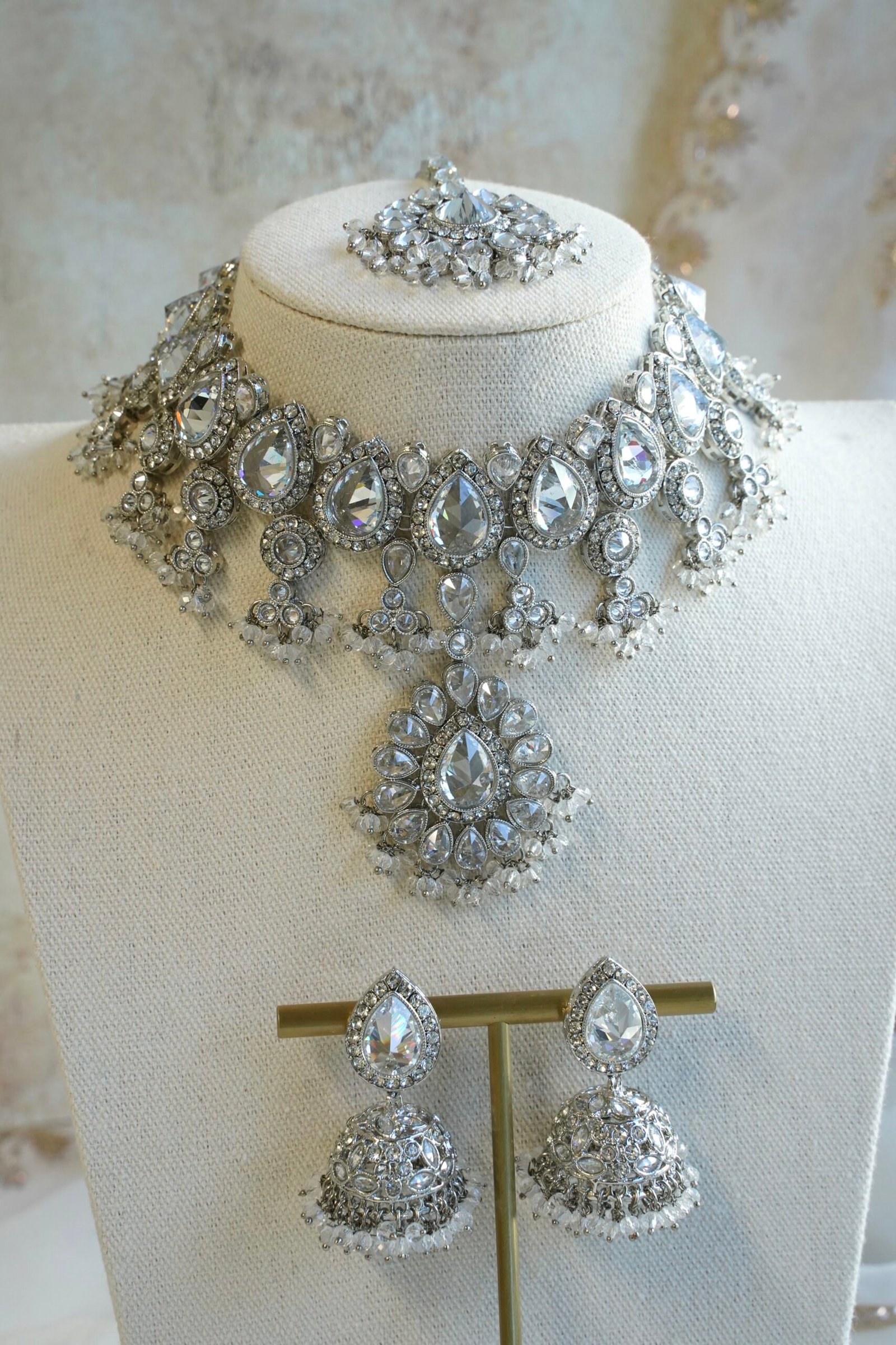 Amyra silver choker necklace set with clear stones, pendant drop, tikka, and jhumka earrings