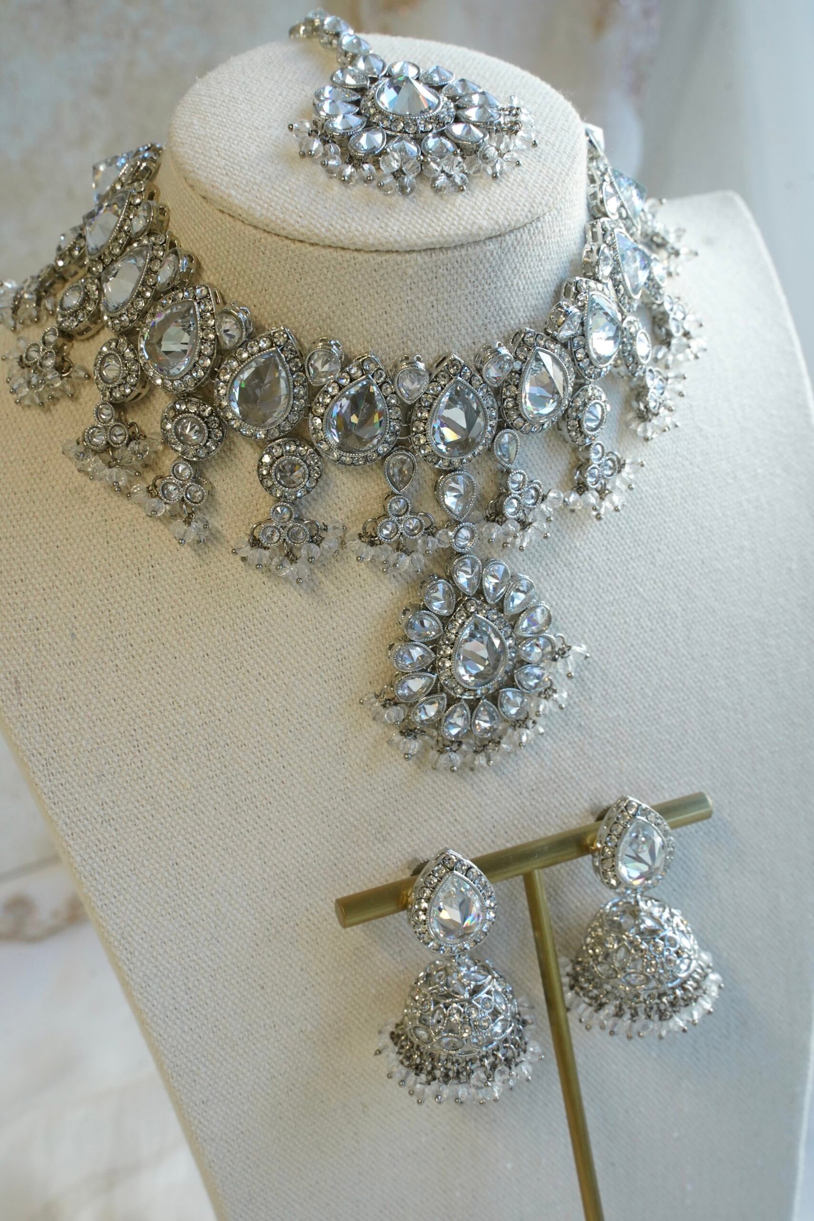 Amyra silver choker necklace set with clear stones, pendant drop, tikka, and jhumka earrings