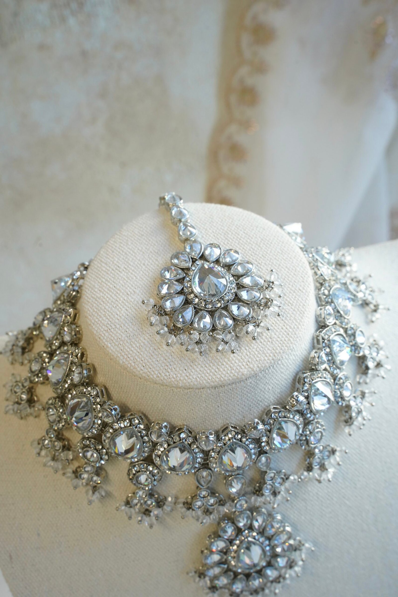 Amyra silver choker necklace set with clear stones, pendant drop, tikka, and jhumka earrings
