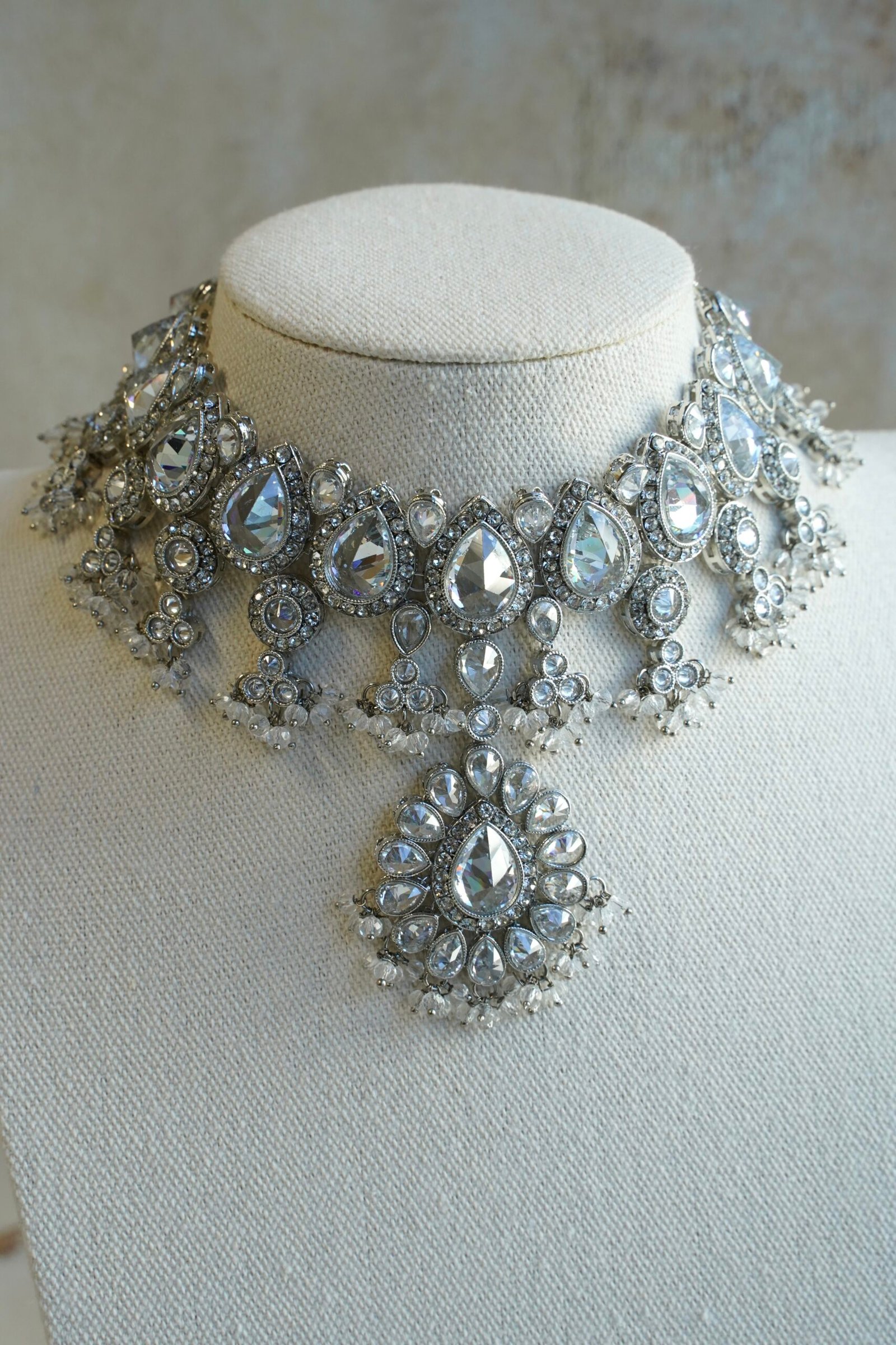 Amyra silver choker necklace set with clear stones, pendant drop, tikka, and jhumka earrings