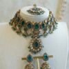 Amyra teal choker necklace set with pendant drop, tikka, and jhumka earrings in antique gold tone