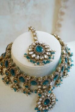 Amyra teal choker necklace set with pendant drop, tikka, and jhumka earrings in antique gold tone
