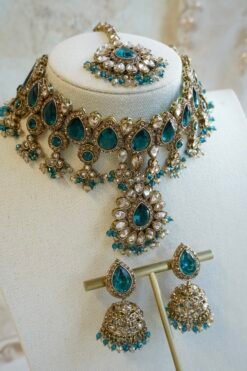 Amyra teal choker necklace set with pendant drop, tikka, and jhumka earrings in antique gold tone