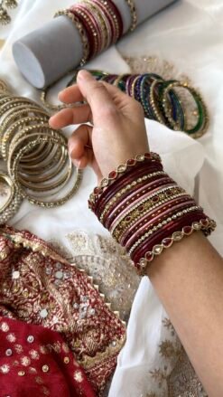 Hina maroon, wine, and dusty pink velvet stacked bangle set with red and champagne stone bangles in antique gold tone