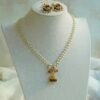 Kamini pendant set with pearl-style bead strands, a gold-tone jhumka pendant and matching jhumka earrings. Ready to ship from the USA. Shop now.