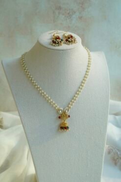 Kamini pendant set with pearl-style bead strands, a gold-tone jhumka pendant and matching jhumka earrings. Ready to ship from the USA. Shop now.