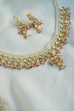 Small pachi necklace set with woven beaded neckline, clear teardrop stones, wine red bead drops, and matching earrings