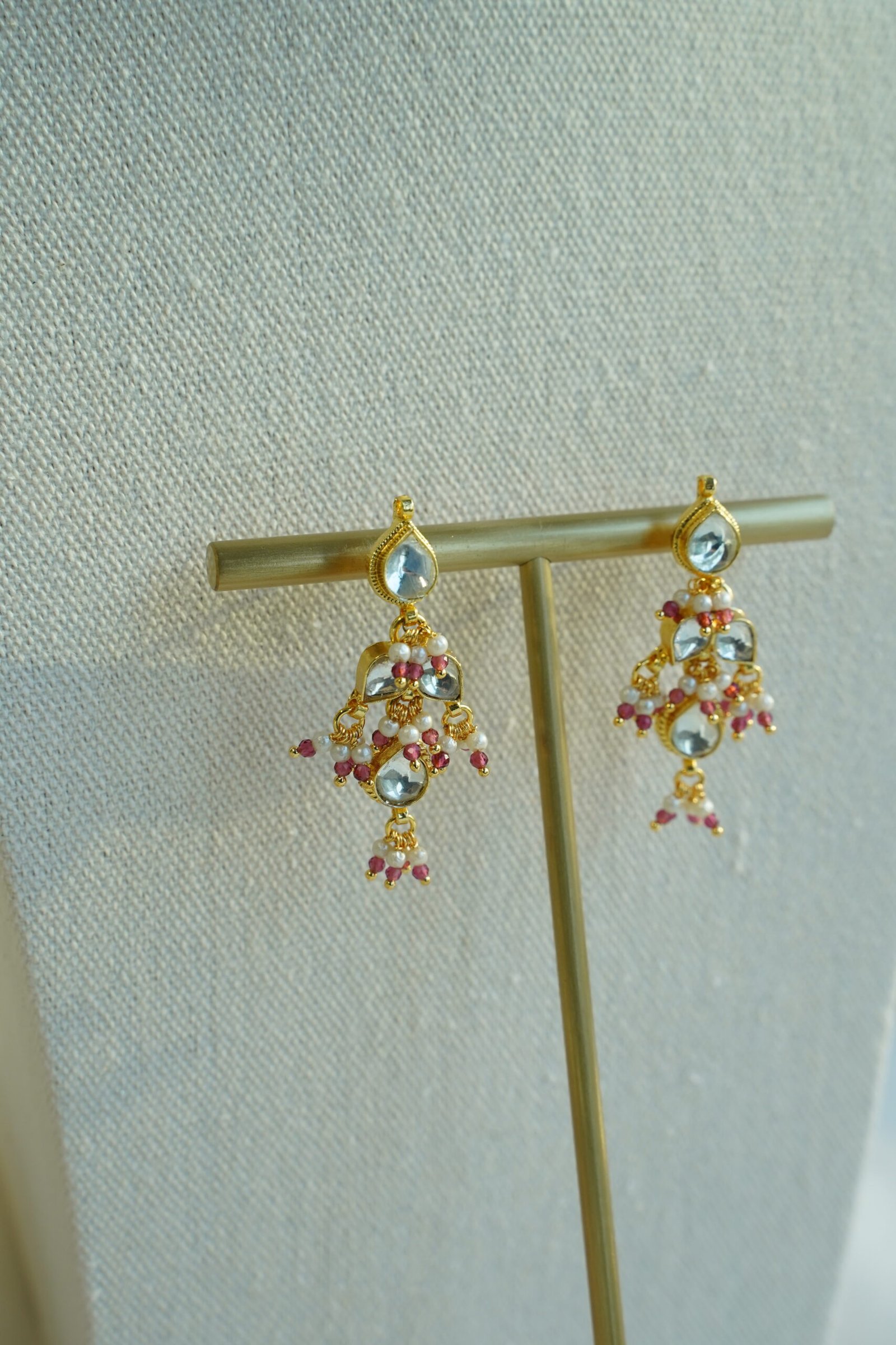 Small pachi necklace set with woven beaded neckline, clear teardrop stones, wine red bead drops, and matching earrings