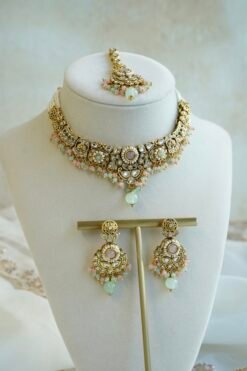 Somya pastel beaded artificial kundan set with mint and pink beads, antique gold necklace, matching earrings and tikka displayed on a bust
