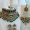 Zeenat green bridal set with layered choker necklace, jhumar, jhumka earrings, and tikka in antique gold tone