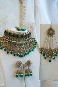 Zeenat green bridal set with layered choker necklace, jhumar, jhumka earrings, and tikka in antique gold tone