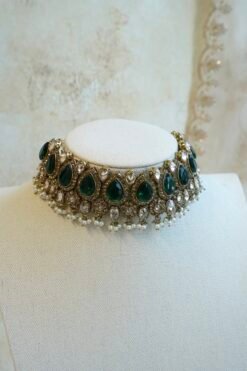 Zeenat green bridal set with layered choker necklace, jhumar, jhumka earrings, and tikka in antique gold tone