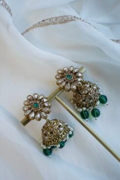 Zeenat green bridal set with layered choker necklace, jhumar, jhumka earrings, and tikka in antique gold tone