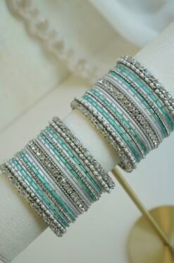 Silver blue stacked bangle set with aqua blue and white bangles, silver tone stone strips, and beaded edges