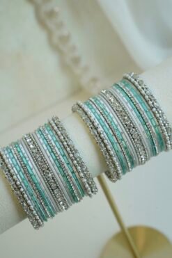 Silver blue stacked bangle set with aqua blue and white bangles, silver tone stone strips, and beaded edges