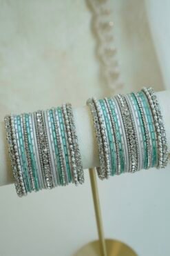 Silver blue stacked bangle set with aqua blue and white bangles, silver tone stone strips, and beaded edges